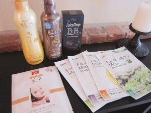 Background: facial gel exfoliator and foaming cleanser (both made in Japan); Juicy Drop BB Cream (made in Korea) Foreground: a variety of sheet masks (all made in Korea)